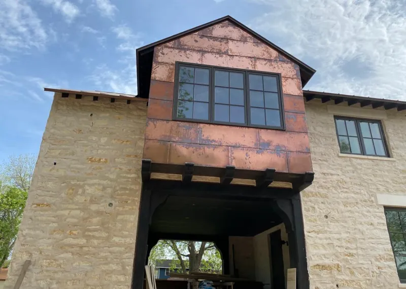 Copper metal panel facade on a stone building for Skylight Installation in Hayden